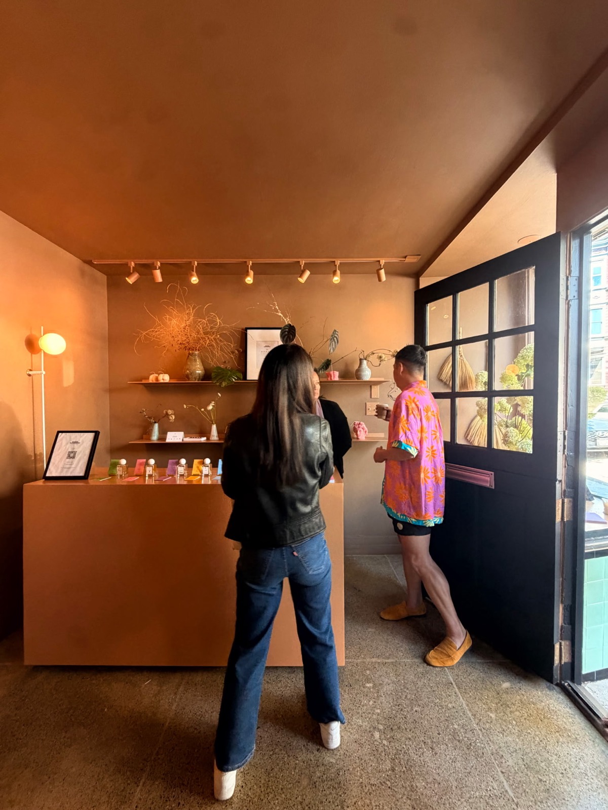 Visitors discovering perfumes at the Maison counter